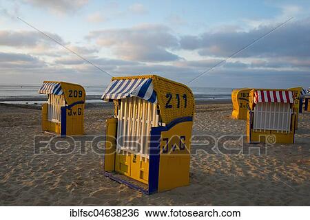 Stock Photograph - Yellow beach chairs during off-season, Duhnen, Cuxhaven, Lower Saxony, Germany, Europe. Fotosearch