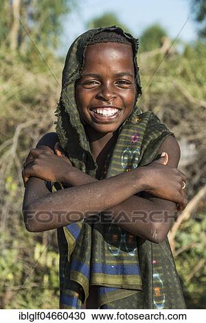 Young boy, approx. 12 years, posing smiling with crossed arms, Hamer tribe, Turmi market, Southern Nations Nationalities and Peoples' Region, Ethiopia, Africa View Large Photo Image Stock Image - Young boy, approx. 12 years, posing smiling with crossed arms, Hamer tribe, Turmi market, Southern Nations Nationalities and Peoples' Region, Ethiopia, Africa. Fotosearch