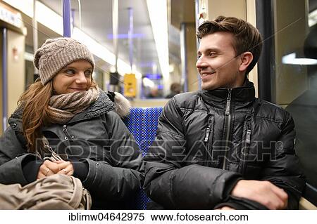 Stock Photography - Young couple, in love, sitting in urban railway, Stuttgart, Baden-Württemberg, Germany, Europe. Fotosearch