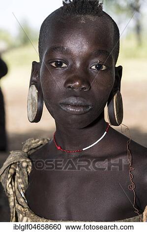 Stock Image - Young girl, portrait, tribe of the Mursi, Southern Nations Nationalities and Peoples' Region, Ethiopia, Africa. Fotosearch