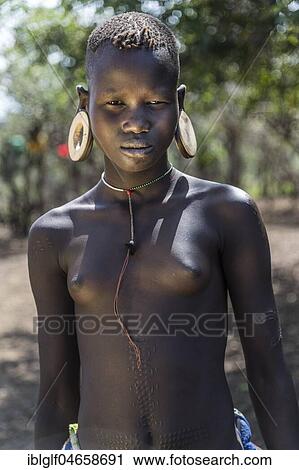 Young girl with ornamental scars on her body, portrait, Mursi tribe, Southern Nations Nationalities and Peoples' Region, Ethiopia, Africa View Large Photo Image Stock Image - Young girl with ornamental scars on her body, portrait, Mursi tribe, Southern Nations Nationalities and Peoples' Region, Ethiopia, Africa. Fotosearch
