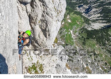 Young man climbing a rock face, via ferrata to the Seekarlspitze, 5-summit via ferrata, hike at the Rofangebirge, Tyrol, Austria, Europe View Large Photo Image Stock Image - Young man climbing a rock face, via ferrata to the Seekarlspitze, 5-summit via ferrata, hike at the Rofangebirge, Tyrol, Austria, Europe. Fotosearch