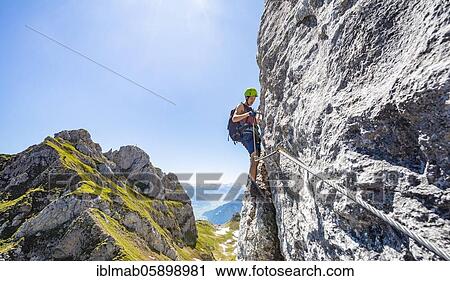 Young man climbing a rock face, via ferrata to the Seekarlspitze, 5-summit via ferrata, hike at the Rofangebirge, Tyrol, Austria, Europe View Large Photo Image Stock Image - Young man climbing a rock face, via ferrata to the Seekarlspitze, 5-summit via ferrata, hike at the Rofangebirge, Tyrol, Austria, Europe. Fotosearch
