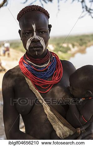 Young woman breastfeeding baby, Karo tribe, Omo River, Southern Nations Nationalities and Peoples' Region, Ethiopia, Africa View Large Photo Image Stock Image - Young woman breastfeeding baby, Karo tribe, Omo River, Southern Nations Nationalities and Peoples' Region, Ethiopia, Africa. Fotosearch