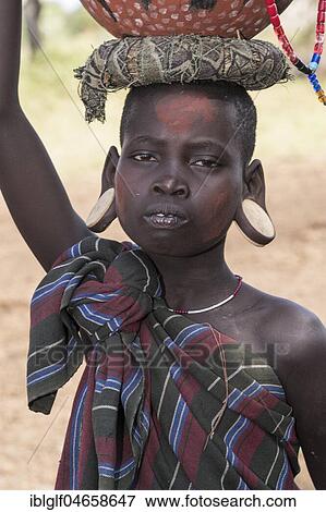 Stock Photo - Young woman, portrait, tribe of the Mursi, Southern Nations Nationalities and Peoples' Region, Ethiopia, Africa. Fotosearch