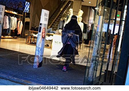 Stock Image - Young woman with burka shopping in Munich, Germany, Europe. Fotosearch