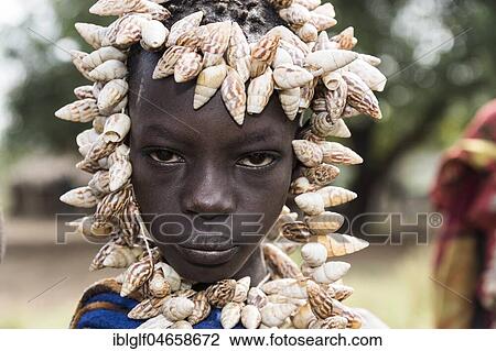 Young woman with headdress made of shells, portrait, tribe of the Mursi, Southern Nations Nationalities and Peoples' Region, Ethiopia, Africa View Large Photo Image Stock Image - Young woman with headdress made of shells, portrait, tribe of the Mursi, Southern Nations Nationalities and Peoples' Region, Ethiopia, Africa. Fotosearch