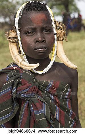 Young woman with headdress, portrait, tribe of the Mursi, Southern Nations Nationalities and Peoples' Region, Ethiopia, Africa View Large Photo Image Picture - Young woman with headdress, portrait, tribe of the Mursi, Southern Nations Nationalities and Peoples' Region, Ethiopia, Africa. Fotosearch