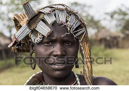 Young woman with headdress, portrait, tribe of the Mursi, Southern Nations Nationalities and Peoples' Region, Ethiopia, Africa View Large Photo Image Stock Image - Young woman with headdress, portrait, tribe of the Mursi, Southern Nations Nationalities and Peoples' Region, Ethiopia, Africa. Fotosearch