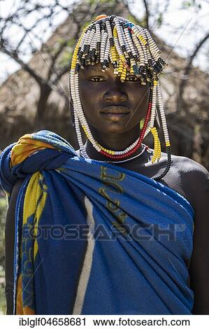 Stock Image - Young woman with headdress, portrait, tribe of the Mursi, Southern Nations Nationalities and Peoples' Region, Ethiopia, Africa. Fotosearch