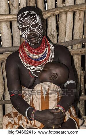 Stock Photography - Young woman with painted face and baby, Karo tribe, Southern Nations Nationalities and Peoples' Region, Ethiopia, Africa. Fotosearch