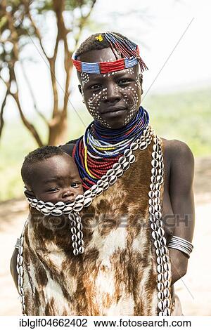 Young woman with toddler in traditional clothes made of goatskin, Karo tribe, Southern Nations Nationalities and Peoples' Region, Ethiopia, Africa View Large Photo Image Stock Image - Young woman with toddler in traditional clothes made of goatskin, Karo tribe, Southern Nations Nationalities and Peoples' Region, Ethiopia, Africa. Fotosearch