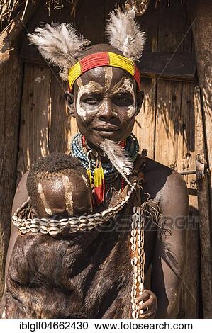 Young woman with toddler in traditional clothes made of goatskin, Karo tribe, Southern Nations Nationalities and Peoples' Region, Ethiopia, Africa View Large Photo Image Stock Image - Young woman with toddler in traditional clothes made of goatskin, Karo tribe, Southern Nations Nationalities and Peoples' Region, Ethiopia, Africa. Fotosearch