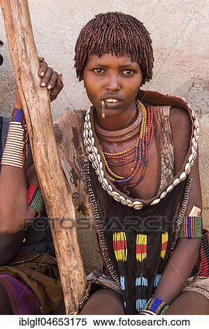 Young woman with traditional clothes from the Hamer tribe, Turmi, region of southern nations, nationalities and peoples, Ethiopia, Africa View Large Photo Image Stock Photography - Young woman with traditional clothes from the Hamer tribe, Turmi, region of southern nations, nationalities and peoples, Ethiopia, Africa. Fotosearch