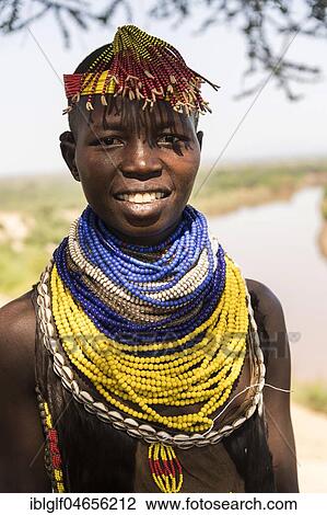Stock Image - Young woman with traditional jewelry, portrait, Karo tribe, Omo River, Southern Nations Nationalities and Peoples' Region, Ethiopia, Africa. Fotosearch