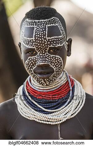 Young woman with traditionally painted face, portrait, Karo tribe, Southern Nations Nationalities and Peoples' Region, Ethiopia, Africa View Large Photo Image Stock Photo - Young woman with traditionally painted face, portrait, Karo tribe, Southern Nations Nationalities and Peoples' Region, Ethiopia, Africa. Fotosearch