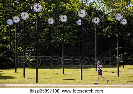 Zeitfeld artwork, 24 synchronously running station clocks, artist Klaus Rinke, Volksgarten, Düsseldorf, North Rhine-Westphalia, Germany, Europe View Large Photo Image Stock Photo - Zeitfeld artwork, 24 synchronously running station clocks, artist Klaus Rinke, Volksgarten, Düsseldorf, North Rhine-Westphalia, Germany, Europe. Fotosearch