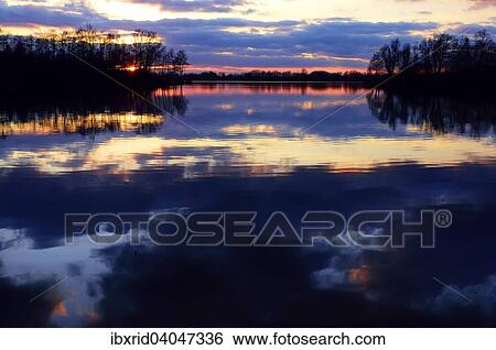 Abendstimmung am See mit Baumen und Spiegelung der Wolken, Alpen-Menzelen, Nordrhein-Westfalen, Deutschland, Europa View Large Photo Image Stock Photograph - Abendstimmung am See mit Baumen und Spiegelung der Wolken, Alpen-Menzelen, Nordrhein-Westfalen, Deutschland, Europa. Fotosearch