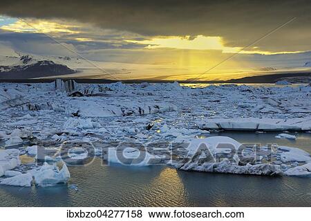 Abendstimmung an der Gletscherlagune Jokulsarlon, treibende Eisberge, hinten der Gletscher Vatnajokull, Sudisland, Island, Europa View Large Photo Image Stock Photo - Abendstimmung an der Gletscherlagune Jokulsarlon, treibende Eisberge, hinten der Gletscher Vatnajokull, Sudisland, Island, Europa. Fotosearch