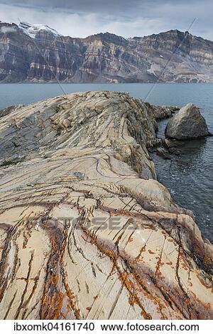 Aufgefaltete farbige Gesteinsschichten, ehemals Meeressedimente, Berzelius Bjerg, Segelsallskapet oder Segelselskapets Fjord, Nordost-Gronland-Nationalpark, Gronland, Nordamerika View Large Photo Image Stock Image - Aufgefaltete farbige Gesteinsschichten, ehemals Meeressedimente, Berzelius Bjerg, Segelsallskapet oder Segelselskapets Fjord, Nordost-Gronland-Nationalpark, Gronland, Nordamerika. Fotosearch