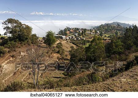 Ausblick auf Landschaft, landliche Hauser, Terrassenfelder und Berge des Himalaya, Nebel liegt im Tal, bei Dhulikel, Nepal, Asien View Large Photo Image Stock Photo - Ausblick auf Landschaft, landliche Hauser, Terrassenfelder und Berge des Himalaya, Nebel liegt im Tal, bei Dhulikel, Nepal, Asien. Fotosearch