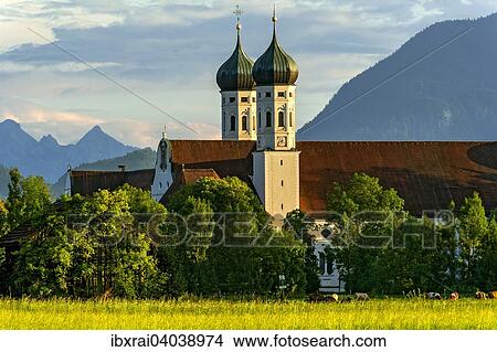 Basilika St. Benedikt, Benediktinerabtei Kloster Benediktbeuern, hinten rechts Herzogstand der Voralpen, ganz hinten Arnspitzgruppe im Wettersteingebirge der Alpen, Benediktbeuern, Oberbayern, Bayern, Deutschland, Europa View Large Photo Image Picture - Basilika St. Benedikt, Benediktinerabtei Kloster Benediktbeuern, hinten rechts Herzogstand der Voralpen, ganz hinten Arnspitzgruppe im Wettersteingebirge der Alpen, Benediktbeuern, Oberbayern, Bayern, Deutschland, Europa. Fotosearch