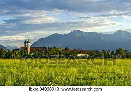 Basilika St. Benedikt, Benediktinerabtei Kloster Benediktbeuern, hinten rechts Herzogstand und Heimgarten der Voralpen, ganz hinten Arnspitzgruppe im Wettersteingebirge der Alpen, Benediktbeuern, Oberbayern, Bayern, Deutschland, Europa View Large Photo Image Stock Image - Basilika St. Benedikt, Benediktinerabtei Kloster Benediktbeuern, hinten rechts Herzogstand und Heimgarten der Voralpen, ganz hinten Arnspitzgruppe im Wettersteingebirge der Alpen, Benediktbeuern, Oberbayern, Bayern, Deutschland, Europa. Fotosearch