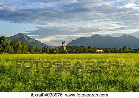 Basilika St. Benedikt, Benediktinerabtei Kloster Benediktbeuern, hinten links Jochberg, rechts Herzogstand und Heimgarten der Voralpen, ganz hinten Arnspitzgruppe im Wettersteingebirge der Alpen, Benediktbeuern, Oberbayern, Bayern, Deutschland, Europa View Large Photo Image Stock Photograph - Basilika St. Benedikt, Benediktinerabtei Kloster Benediktbeuern, hinten links Jochberg, rechts Herzogstand und Heimgarten der Voralpen, ganz hinten Arnspitzgruppe im Wettersteingebirge der Alpen, Benediktbeuern, Oberbayern, Bayern, Deutschland, Europa. Fotosearch