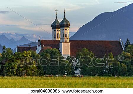 Basilika St. Benedikt, Benediktinerabtei Kloster Benediktbeuern, hinten rechts Herzogstand der Voralpen, ganz hinten Arnspitzgruppe im Wettersteingebirge der Alpen, Benediktbeuern, Oberbayern, Bayern, Deutschland, Europa View Large Photo Image Stock Photography - Basilika St. Benedikt, Benediktinerabtei Kloster Benediktbeuern, hinten rechts Herzogstand der Voralpen, ganz hinten Arnspitzgruppe im Wettersteingebirge der Alpen, Benediktbeuern, Oberbayern, Bayern, Deutschland, Europa. Fotosearch