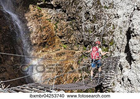Bergsteiger auf Hangebrucke mit Wasserfall, Klettersteig Vallonsteig, Piz Boe, Sella Gruppe, Dolomiten, Corvara, Sudtirol, Trentino-Sudtirol, Alpen, Italien, Europa View Large Photo Image Stock Image - Bergsteiger auf Hangebrucke mit Wasserfall, Klettersteig Vallonsteig, Piz Boe, Sella Gruppe, Dolomiten, Corvara, Sudtirol, Trentino-Sudtirol, Alpen, Italien, Europa. Fotosearch