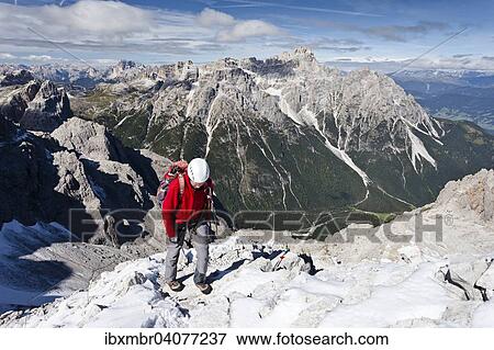 Bergsteiger beim Aufstieg uber den Rotwandsteig auf die Sextner Rotwand in den Sextner Dolomiten, hier oberhalb der Rotwandwiesen, hinten die Dreischusterspitze, unten das Altsteintal, Hochpustertal, Sudtirol, Trentino-Sudtirol, Italien, Europa View Large Photo Image Stock Photo - Bergsteiger beim Aufstieg uber den Rotwandsteig auf die Sextner Rotwand in den Sextner Dolomiten, hier oberhalb der Rotwandwiesen, hinten die Dreischusterspitze, unten das Altsteintal, Hochpustertal, Sudtirol, Trentino-Sudtirol, Italien, Europa. Fotosearch