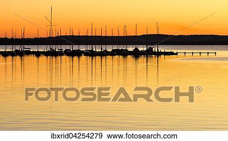 Stock Photo - Bootsanleger mit Segelbooten bei Abendrot, Steinhuder Meer, Steinhude, Niedersachsen, Deutschland, Europa. Fotosearch