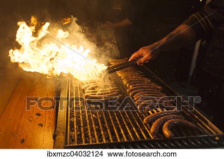 Bratwurste auf dem Grill mit Flammen auf einem Weihnachtsmarkt, Bayern, Deutschland, Europa View Large Photo Image Picture - Bratwurste auf dem Grill mit Flammen auf einem Weihnachtsmarkt, Bayern, Deutschland, Europa. Fotosearch