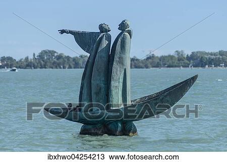 Stock Image - Bronze Denkmal fur Dante, 2007, stehend in einer Barke, Virgil weist zur Friedhofsinsel San Michele, russischer Bildhauer George Frangulyan, Lagune von Venedig, Venetien, Italien, Europa. Fotosearch