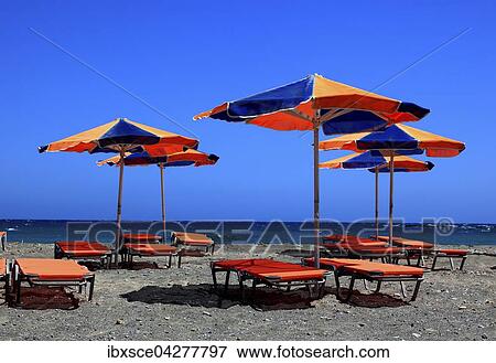 Bunte Liegestuhle und Sonnenschirme am Strand mit blauem Meer, Kreta, Griechenland, Europa View Large Photo Image Stock Photo - Bunte Liegestuhle und Sonnenschirme am Strand mit blauem Meer, Kreta, Griechenland, Europa. Fotosearch