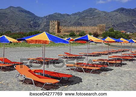 Stock Photo - Bunte Liegestuhle und Sonnenschirme vor Burg Frangokastello, Kreta, Griechenland, Europa. Fotosearch