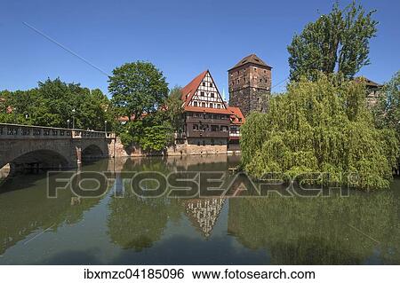 Stock Photograph - Ehemaliger Weinstadl, 1446-48 als Sondersiechenhaus erbaut, rechts der ehemalige Wasserturm, links die Maxbrucke, vorne die Pegnitz, Nurnberg, Mittelfranken, Bayern, Deutschland, Europa. Fotosearch