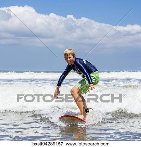 Ein Junge, 12 Jahre, beim Surfen, Kuta, Legian, Strand und Surfparadies, Bali, Indonesien, Asien View Large Photo Image Stock Photo - Ein Junge, 12 Jahre, beim Surfen, Kuta, Legian, Strand und Surfparadies, Bali, Indonesien, Asien. Fotosearch