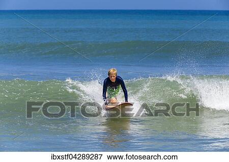 Ein Junge, 12 Jahre, beim Surfen, Kuta, Legian, Strand und Surfparadies, Bali, Indonesien, Asien View Large Photo Image Stock Photo - Ein Junge, 12 Jahre, beim Surfen, Kuta, Legian, Strand und Surfparadies, Bali, Indonesien, Asien. Fotosearch