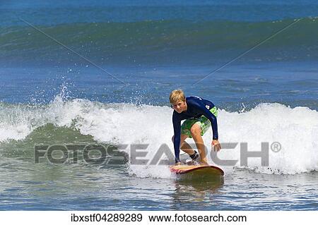 Ein Junge, 12 Jahre, beim Surfen, Kuta, Legian, Strand und Surfparadies, Bali, Indonesien, Asien View Large Photo Image Stock Photo - Ein Junge, 12 Jahre, beim Surfen, Kuta, Legian, Strand und Surfparadies, Bali, Indonesien, Asien. Fotosearch