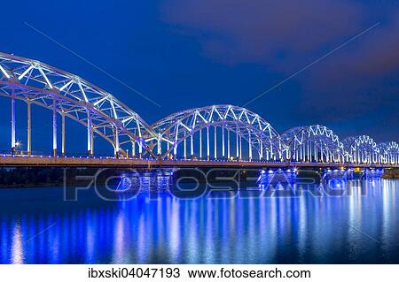 Eisenbahnbrucke, Dzelzcelabrucke, Dzelzce??a tilts, zur blauen Stunde, uber den Fluss Daugave, Duna, Riga, Lettland, Europa View Large Photo Image Stock Image - Eisenbahnbrucke, Dzelzcelabrucke, Dzelzce??a tilts, zur blauen Stunde, uber den Fluss Daugave, Duna, Riga, Lettland, Europa. Fotosearch