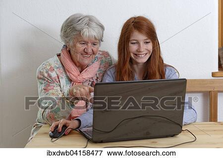 Enkelin und Grossmutter am Laptop, Bayern, Deutschland, Europa View Large Photo Image Stock Photo - Enkelin und Grossmutter am Laptop, Bayern, Deutschland, Europa. Fotosearch