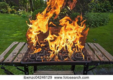 Stock Photo - Flammen im Kohlegrill. Fotosearch