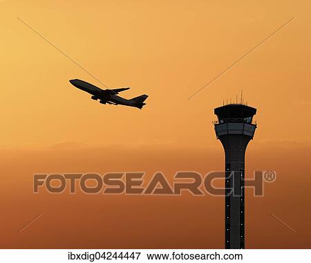 Flugsicherungsturm mit einem startenden Flugzeug bei Sonnenuntergang, Luton Airport, Grossbritannien, Europa View Large Photo Image Stock Photo - Flugsicherungsturm mit einem startenden Flugzeug bei Sonnenuntergang, Luton Airport, Grossbritannien, Europa. Fotosearch
