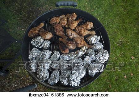 Folienkartoffeln und Hahnchenschenkel auf einem Grill, Deutschland, Europa View Large Photo Image Stock Photograph - Folienkartoffeln und Hahnchenschenkel auf einem Grill, Deutschland, Europa. Fotosearch