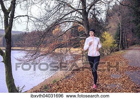 Frau beim Joggen am Seeufer, Scheibe-Alsbach, Thuringen, Deutschland, Europa View Large Photo Image Stock Photograph - Frau beim Joggen am Seeufer, Scheibe-Alsbach, Thuringen, Deutschland, Europa. Fotosearch