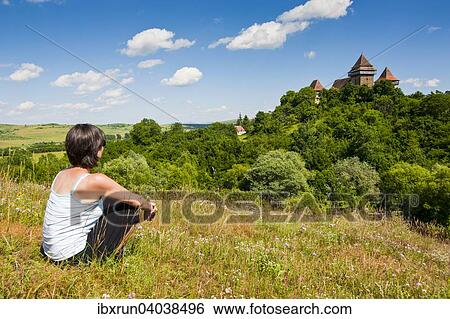 Frau blickt auf den Kirchenburg von Viscri, UNESCO Weltkulturerbe, Viscri, Rumanien, Europa View Large Photo Image Stock Photograph - Frau blickt auf den Kirchenburg von Viscri, UNESCO Weltkulturerbe, Viscri, Rumanien, Europa. Fotosearch