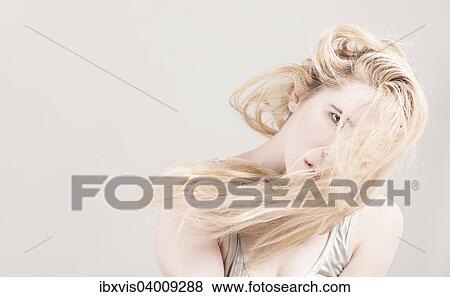 Frau mit langen blonden Haaren, die ihr Gesicht bedecken View Large Photo Image Stock Photo - Frau mit langen blonden Haaren, die ihr Gesicht bedecken. Fotosearch