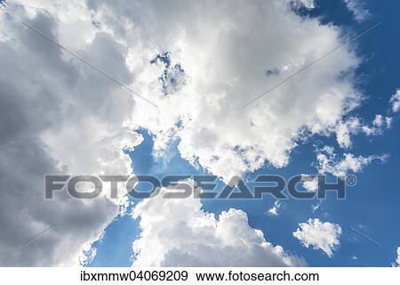 Grosse weisse Wolken vor blauem Himmel View Large Photo Image Stock Photo - Grosse weisse Wolken vor blauem Himmel. Fotosearch