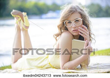 Hubsches Madchen mit Brille und Buch liegt auf einer Wiese an der Moskwa, Serebryany Bor Park, Moskau, Russland, Europa View Large Photo Image Stock Image - Hubsches Madchen mit Brille und Buch liegt auf einer Wiese an der Moskwa, Serebryany Bor Park, Moskau, Russland, Europa. Fotosearch